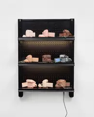 Josh Kline, Stories, 2016, cast silicone, metal handcuffs, inkjet cyanoacrylate, commercial shelving with LED lights and power cable
