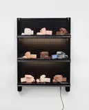 Josh Kline, Stories, 2016, cast silicone, metal handcuffs, inkjet cyanoacrylate, commercial shelving with LED lights and power cable