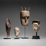 African, Collection of four masks, carved wood, kaolin