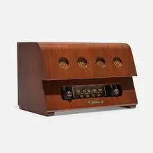 Radio by Charles and Ray Eames, c. 1946, walnut veneer, Bakelite, plastic, enameled aluminum, sold May 2025