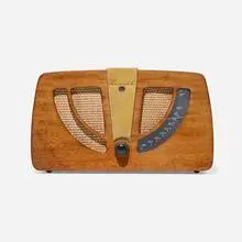 Radio, model 6D030 by Charles and Ray Eames, 1946, mahogany plywood, brass, fabric, Bakelite, plastic, sold May 2025
