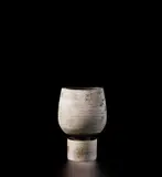 Hans Coper, Pot on cylindrical foot, circa 1972, Stoneware, layered white porcelain slips and engobes over a body with textured and incised linear designs, the interior with manganese glaze