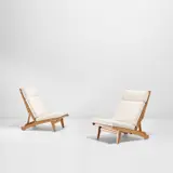Pair of rare adjustable lounge chairs by Hans J. Wegner, circa 1968, Oak, fabric, offered Nov 2021