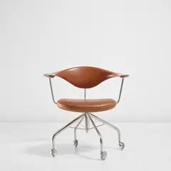 Hans J. Wegner, Swivel armchair, model no. JH502, designed 1955, produced 1960s, Teak, stainless steel, chromium-plated metal, leather, rubber