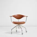 Hans J. Wegner, Swivel armchair, model no. JH502, designed 1955, produced 1960s, Teak, stainless steel, chromium-plated metal, leather, rubber