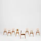 Set of eight 'S 12' side chairs by Ettore Sottsass, circa 1958, Walnut, fabric, patinated metal, sold Nov 2021