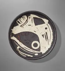 Large dish by Hans Coper, circa 1950, Stoneware, layered white porcelain slips and manganese with the design cut through, sold Nov 2021