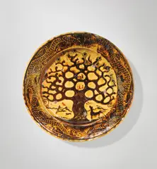 Bernard Leach, Charger with 'Tree of Life' design, circa 1924, Earthenware, galena glaze over slip trailed and carved 'Tree of Life' design, incorporating mustang, stag and hunting dog, bird feeding its young, song birds, Ursa Major and dragon motifs