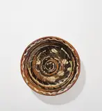 Katherine Pleydell-Bouverie, Large dish, circa 1958, Stoneware, brown ash glazes with cream trailed slip and incised spiralling designs, the underside unglazed with combed design