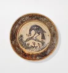 Bernard Leach, Charger with design of bird feeding its young, circa 1924, Earthenware, painted, trailed and carved slip design beneath a galena glaze