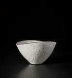 Squeezed bowl by Lucie Rie, circa 1964, Stoneware mixed with managanese minerals beneath a shiny white glaze creating an integral speckle, sold Nov 2021