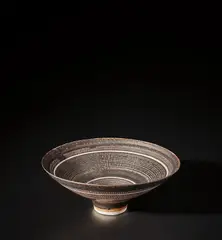 Lucie Rie, Footed bowl, circa 1960, Porcelain, managanese glaze with fine sgraffito grid design repeated inside and out