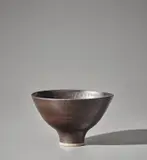Footed bowl by Lucie Rie, circa 1965, Stoneware, pure manganese glaze, sold Nov 2021