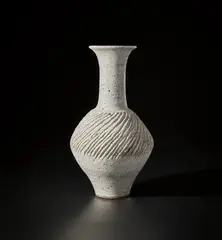 Large vase by Lucie Rie, circa 1960, Stoneware mixed with manganese minerals beneath a white glaze, the body with carved diagonal fluting, sold Nov 2021
