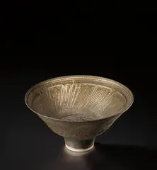 Lucie Rie, Footed bowl, circa 1976, Porcelain, bright golden glaze with horizontal bands of diagonal sgraffito designs repeated inside and out