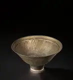 Footed bowl by Lucie Rie, circa 1976, Porcelain, bright golden glaze with horizontal bands of diagonal sgraffito designs repeated inside and out, sold Nov 2021