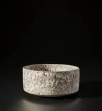 Bulb bowl by Lucie Rie, 1962, Stoneware mixed with manganese minerals beneath a flowing, deeply pitted white glaze with integral speckle, sold Nov 2021