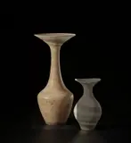 Tall vase with flaring lip by Lucie Rie, circa 1968, Stoneware, mixed clay body combining with a 'Dolomite' glaze to produce an integral spiral of colour with a manganese sp, sold Nov 2021