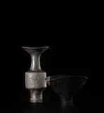 Lucie Rie, 'Black firing' vase with flaring lip, 1981, Stoneware, over-fired black glaze over a body with combed design