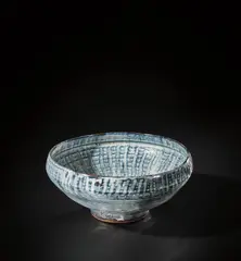 Bowl with 'Basket' pattern by Michael Cardew, circa 1955, Stoneware, vivid blue and white over iron glazes, a finger wipe design beneath the glaze inside and out, sold Nov 2021