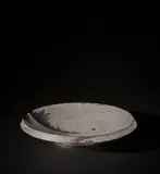 Junko Kitamura, Large dish, circa 2000, Black stoneware, the design impressed and inlaid with porcelain
