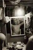 Diane Arbus, Blonde female impersonator framed in a mirror beneath a light bulb, N.Y.C.