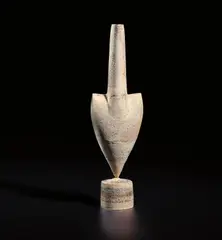 Cycladic arrow form by Hans Coper, circa 1975, Stoneware, layered white porcelain slips and engobes over a body with textured designs, the interior with manganese glaz, sold Jun 2020