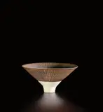 Footed bowl by Lucie Rie, circa 1964, Porcelain, manganese glaze with sgraffito , white well and foot, sold Jun 2020