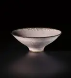 'Knitted' footed bowl by Lucie Rie, circa 1978, Stoneware, inlaid with semi-transparent pink glaze, feathered manganese rim, sold Nov 2020