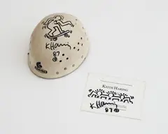 Untitled (Helmet and Invitation) by Keith Haring, 1987, marker pen on helmet and printed paper, sold May 2020