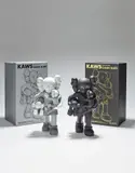 Kaws, Two works: (i) CLEAN SLATE (grey); (ii) CLEAN SLATE (black), 2018, painted vinyl, with original Medicom packaging