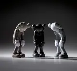 Kaws, Three works: (i) Small Lie (Brown) ; (ii) Small Lie (Black) ; (iii) Small Lie (Grey), 2017, painted vinyl, in original Medicom packaging