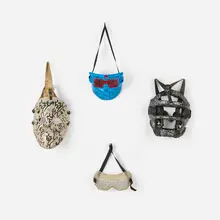 La II, Collection of four masks, c. 1985, paint marker on found objects