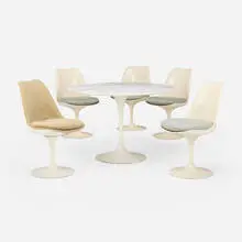 Dining suite by Eero Saarinen, enameled steel and aluminum, marble, fiberglass, upholstery, sold Feb 2025
