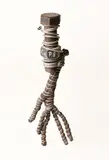 C. O. Paeffgen, Ohne Titel (Umwicklung), 1980, Assemblage (Industrieschraube mit Mutter, Lederhandschuh und Zinkdraht).