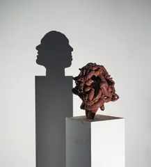 Chocolate narcissus by Tim Noble and Sue Webster, 2008, silicone rubber on wooden plinth with light projector, offered Dec 2019