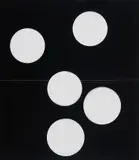 Wade Guyton, Untitled, 2007, Black vinyl paper with circular cut-outs, folded into quarters (as issued), contained in the original cardboard box with screenprint on lid