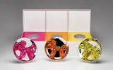 Jeff Koons, Balloon Dogs Presentation Set (Magenta, Orange, Yellow), 2015, The compete set of three porcelain multiples painted in chrome, all contained in the original Styrofoam-lined presentation box with silver printed signature, with the original plastic stands