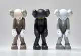 Kaws, Small Lie (Brown); Small Lie (Black); and Small Lie (Grey), 2017, Three painted vinyl multiples, all contained in the original Medicom packaging