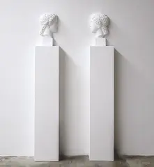 Giulio Paolini, Vis-à-vis (Hera), from Wall Works, 1992, Two halves of a plaster bust on two white painted wooden pedestals, to be installed facing each other, spaced 35 cm apart