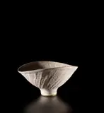 Oval bowl with fluted sides by Lucie Rie, circa 1980, Stoneware with white pitted glaze, sold Oct 2019