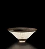 Conical bowl by Lucie Rie, circa 1980, Porcelain, manganese glaze, radiating inlaid and sgraffito design, sold Oct 2019
