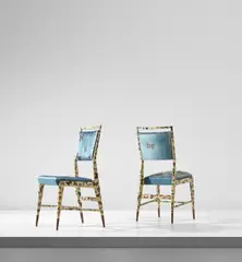 Gio Ponti and Piero Fornasetti, Pair of side chairs, circa 1951, Lithographic transfer-printed wood, walnut, silk