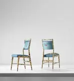 Pair of side chairs by Gio Ponti and Piero Fornasetti, circa 1951, Lithographic transfer-printed wood, walnut, silk, sold Mar 2019