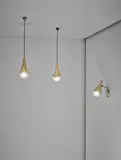 Max Ingrand, Adjustable wall light and pair of ceiling lights, model no. 1849, circa 1958, Tubular brass, brass, opaque glass