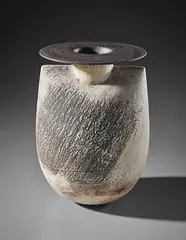 'Sack' form with disc by Hans Coper, circa 1972, Stoneware, layered white porcelain slips and engobes over a body with textured and incised linear designs, the interior , sold Apr 2018