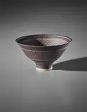 Flaring bowl by Lucie Rie, circa 1972, Porcelain, manganese glaze with sgraffito design, sold Apr 2018