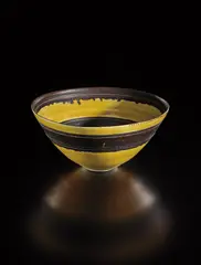 Bowl by Lucie Rie, circa 1964, Porcelain, manganese and yellow glaze with sgraffito, sold Oct 2018