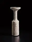 Cylindrical vase with flaring lip by Lucie Rie, early 1960s, Stoneware, white pitted glaze with manganese speckle over diagonally fluted body, sold Oct 2018