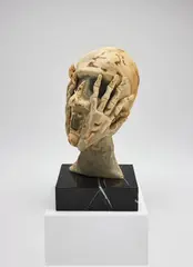Untitled (Head with Hands) by Eva Aeppli, 1969 - 1970, tea and watercolour stained silk and wool on marble base, sold Dec 2017